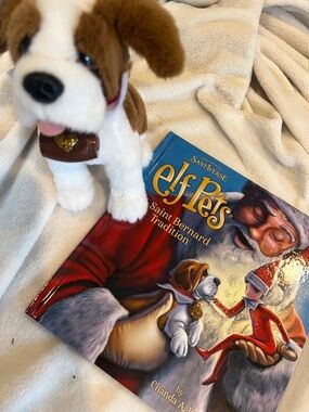 Elf on the shelf Pets Saint Bernard with his adorable story book.
